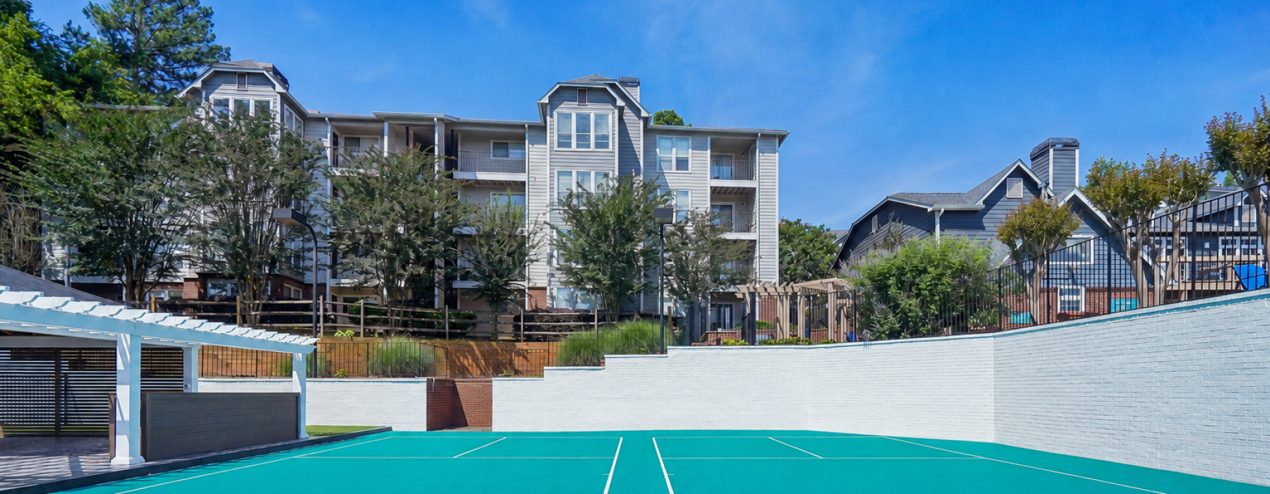 Pickleball court with lights and building in background